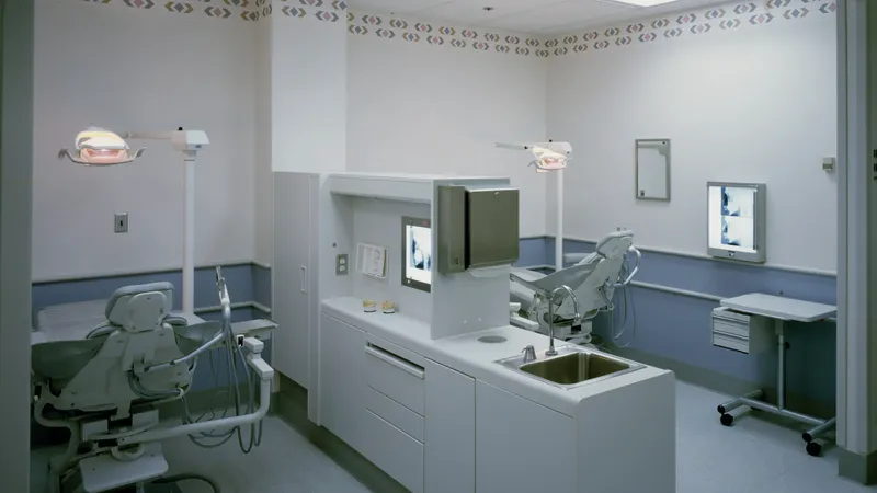 Clean, empty dental treatment rooms with white cabinetry