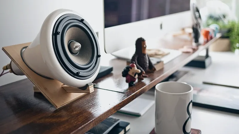 Open laptop and chair at a ready wooden desk
