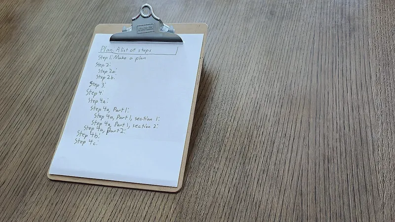 Clipboard on a wooden table holding a handwritten list of steps