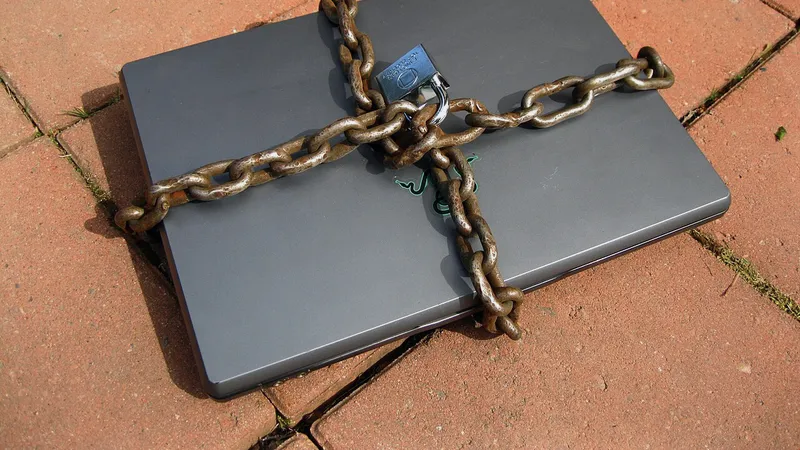 Laptop wrapped in a chain and padlock