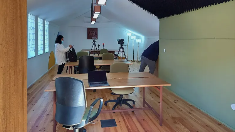 Bright open coworking floor with desks and plants