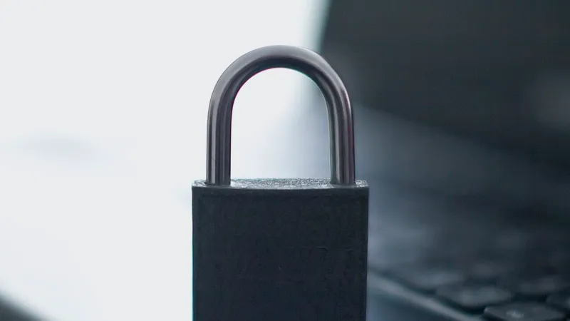 Closed padlock resting on a laptop keyboard