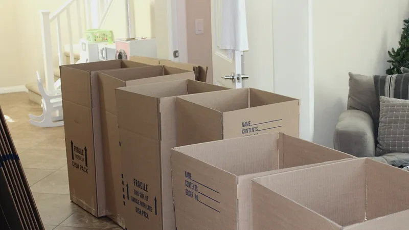 Open cardboard moving boxes in an empty room