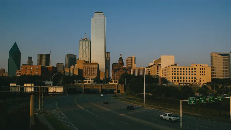 Downtown Dallas skyline towers under a clear blue sky