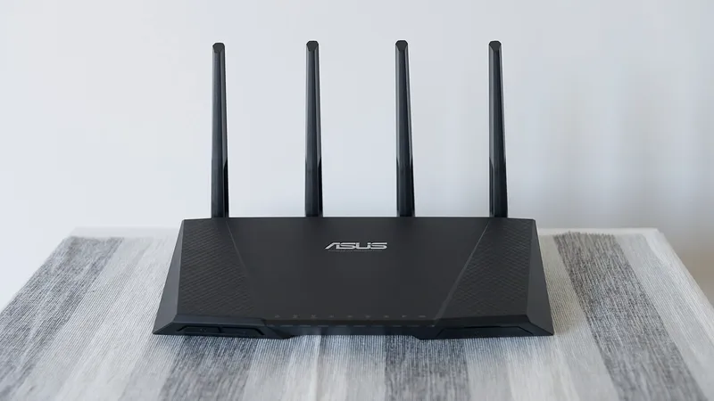 Wireless router with four antennas on a light wooden surface