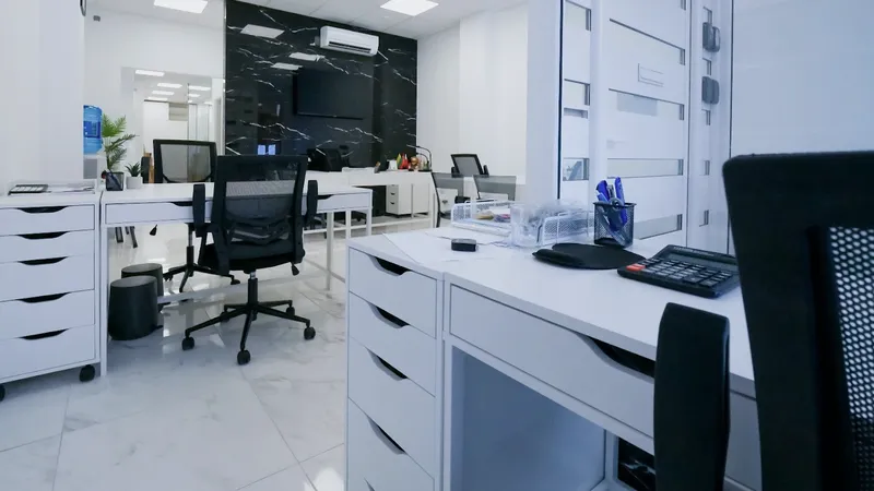 Modern real estate office with desks, chairs and computers